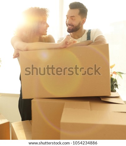Happy couple honeymooners standing near boxes