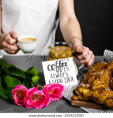 croissants cup of coffee and a bouquet of tulips