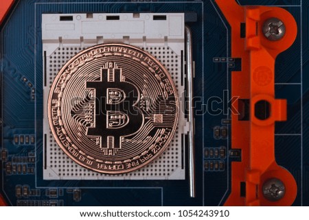 Bitcoin digital currency,  bit-coin on motherboard or electronic board with chips, Cryptocurrency money concept idea.