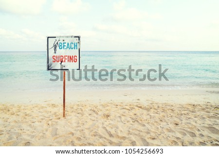 Tropical beach in summer. beach sign for surfing area. Vintage effect color filter.