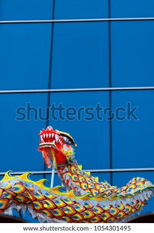 A street dragon dance performance on building background. Asian traditional activity for celebration