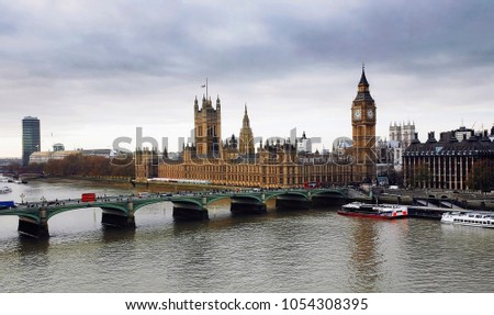 London skyline overlooking various landmarks and Thames River. Image include Westminster Palace, Big Ben, Westminster Bridge, Lambeth Bridge and Routemaster Bus.


