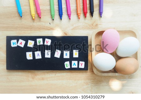 Many colorful pens and eggs are on the wooden table. The picture concepts for Easter, celebration, activity, hopefully with copy space.