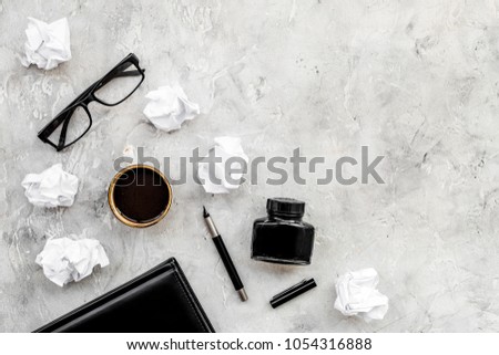 retro and modern writer desktop with glasses, notebook and ink on stone background top view mock up