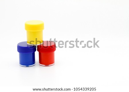 Set of color gouache jars and primary color acrylic paints on white background.