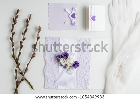 Workspace. Wedding invitation cards, ultraviolet envelopes, ribbons, pussy willow on white background. Overhead view. Flat lay, top view invitation card. copy space. mockup