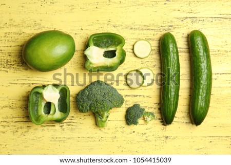 Flat lay composition with green vegetables and fruits on wooden background. Food photography