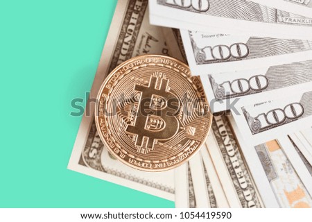Bitcoin is a gold coin on dollar bills. Financial concept