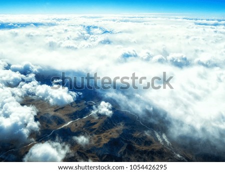 Himalaya mountains under clouds.