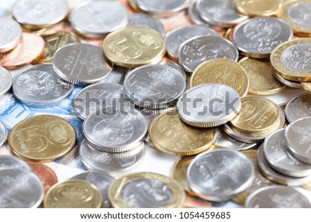 Gold and silver coins scattered in a chaotic order, photo closeup of the Belarus money