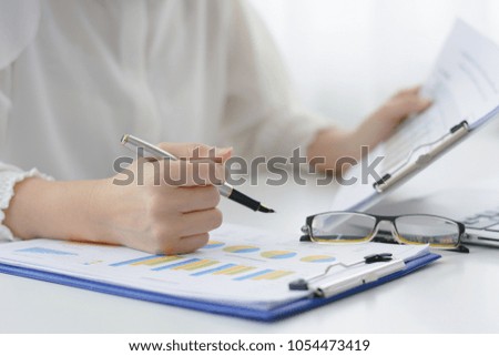 Businesswoman reading growth graph