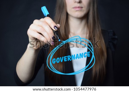 The businessman writes a blue marker inscription:GOVERNANCE