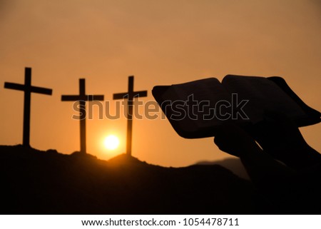    Image silhouette of a christian person reading a bible with rosary, Sunset background., Religion concept.