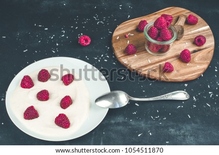 Yogurt plate with raspberries on black background.  Healthy breakfast concept.