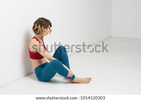 woman in blue leggings doing yoga                               