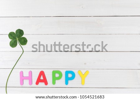 HAPPY initials and four-leaf clover background material