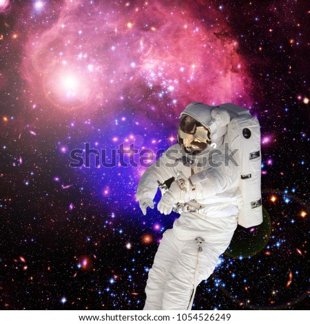 Astronaut flying and deep space on the backdrop. The elements of this image furnished by NASA.