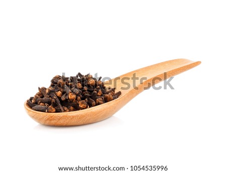 cloves spices on wood spoon isolated on white background