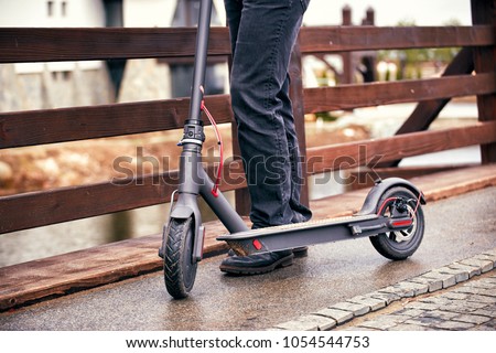 Use of scooter as a means of transportation on the street. Royalty-Free Stock Photo #1054544753