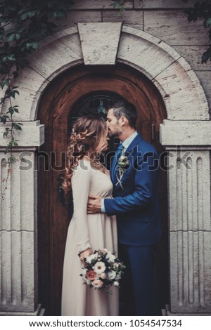 bride and groom kissing each other. vintage toned picture