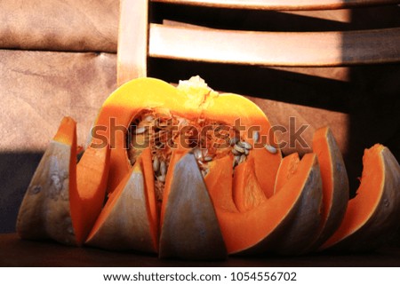 Solar autumn pumpkin on the brown background.
