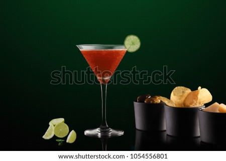 Red Martini with lemon and appetizers