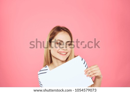 woman smiling holding a sheet of paper, copy space                               