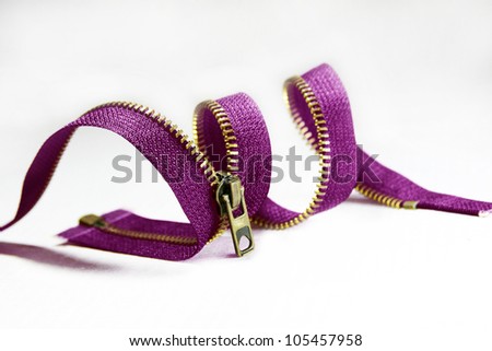 lilac zipper curtailed into a spiral, a snake on a white background
