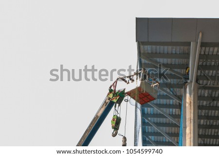 Workers sitting in crane basket