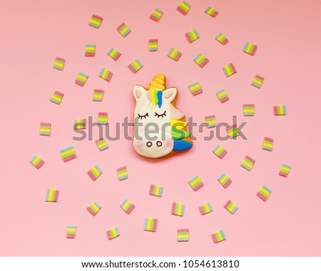 Ginger cookies in the shape of a Unicorn on pink pastel background. Small gifts, souvenirs, postcard. Minimal fashion Stillife. Trendy Bright Colors