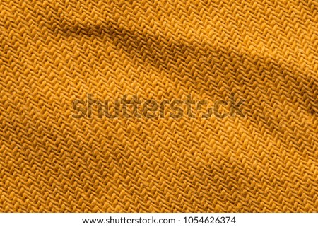 yellow close stitched textile.