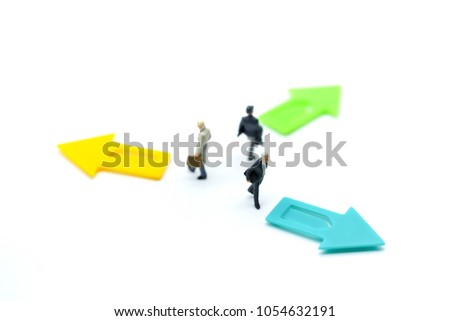 Miniature people: Businessman standing in front of arrow pathway choice using as Business decision concept