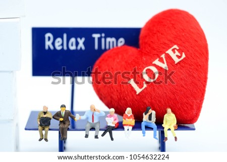 Miniature people : people sitting on chair and doll heart of love,relax time concept.