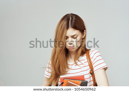 frustrated woman looking at textbooks, student                             