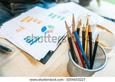 Color of pencils with reporting graph background in working office. 