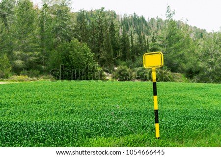 yellow sign on green field