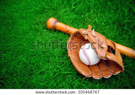 baseball bat, ball and glove on grass with copy space