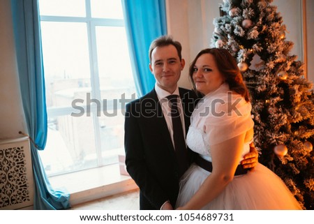 young bride and groom couple in a bright studio photo.