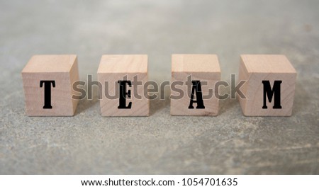 concept word forming with cube on wooden desk background - TEAM