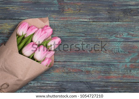 Pink tulips flowers on wooden background. selective focus place for text
