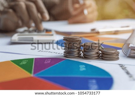 Man using calculator with stock financial indices with stack coin. Financial stock market in accounting market economy analysis.