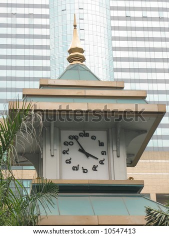 Thai clock tower against high-rise building, Bangkok
