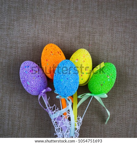 Multicolored easter eggs on a background of gray fabric. Copy space. Easter background.