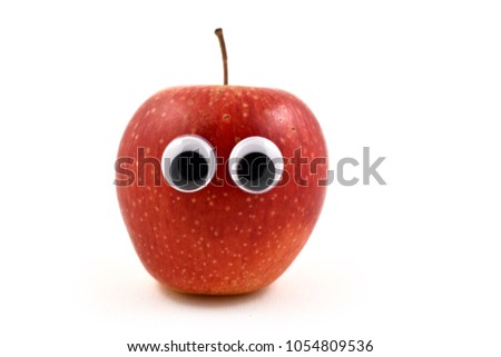 Red apple with eyes stock images. Funny figure of apple. Apple isolated on white background. Apple with face