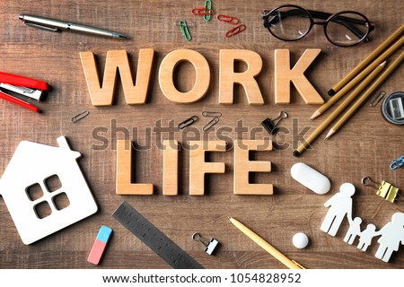 Composition with words WORK, LIFE and stationery on wooden background