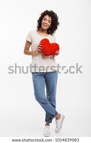 Full length picture of romantic adorable woman 20s with brown hair holding red paper heart in valentine day isolated over white background