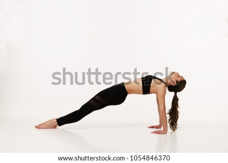 Young girl practicing yoga. Isolated on white background.