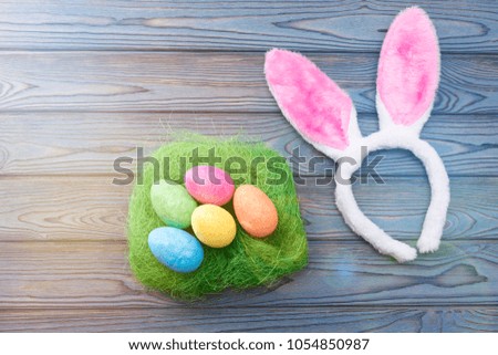 Easter eggs on green grass, ears of a hare. celebration.