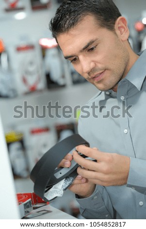 man checking product in store