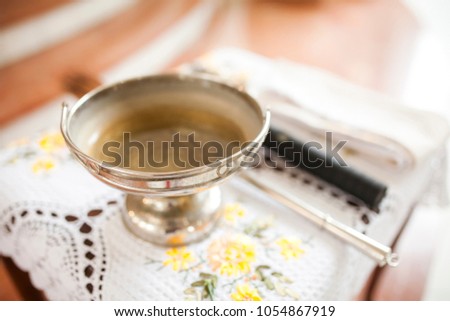 Church silver bowl for ceremony on table inside church blur background